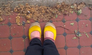 Feet in yellow shoes tiled floor